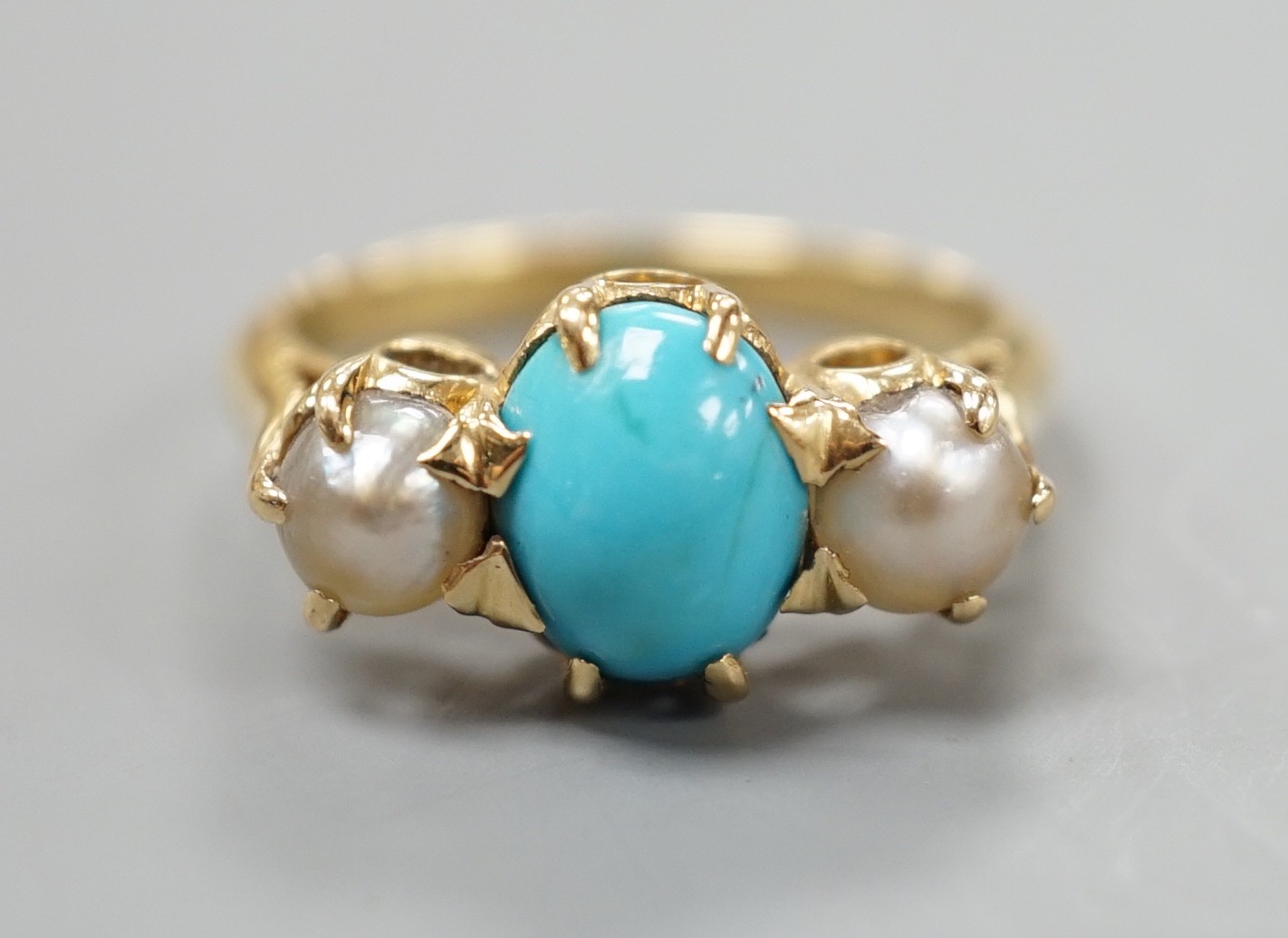 A yellow metal, turquoise and split pearl set three stone ring, size L, gross weight 4.8 grams.